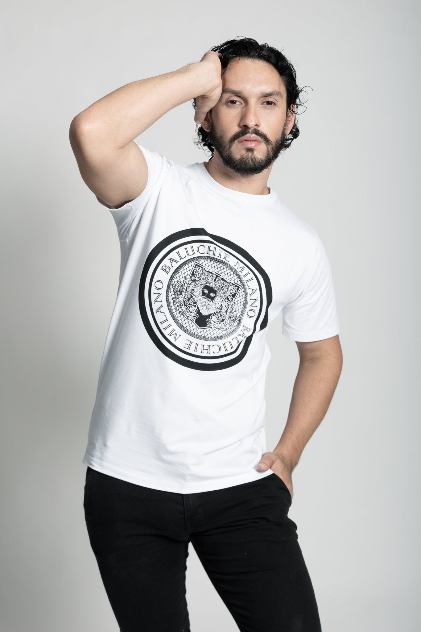 man wearing baluchie milano, t-shirt. posing with a white background.