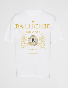 White Baluchie Milano T-shirt featuring gold crest artwork and Roman numeral detailing, designed with regal symmetry and minimalist heritage tones.